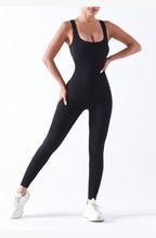 Person wearing a black bodysuit on a white background