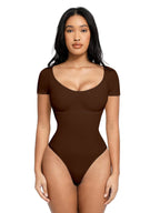 Woman wearing a brown one-piece swimsuit on a white background with 'Global Recycled Standard' logo.