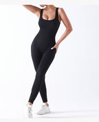 Person wearing a black bodysuit on a white background