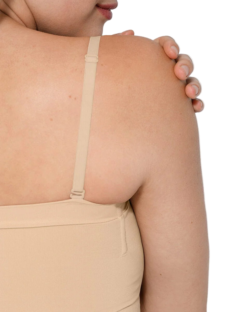 Close-up of a beige strapless top worn by a person on a white background