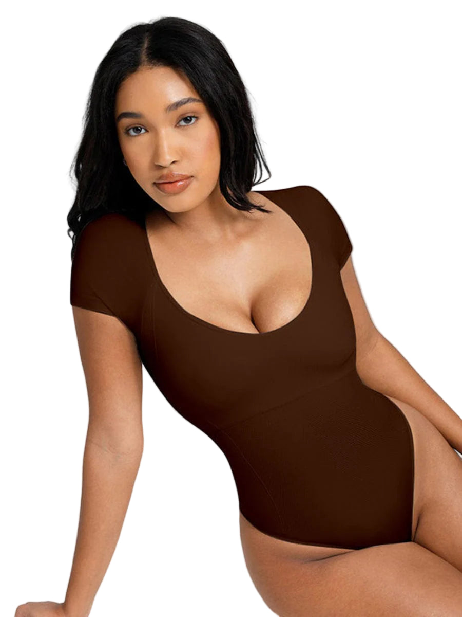 Woman wearing a brown bodysuit against a white background