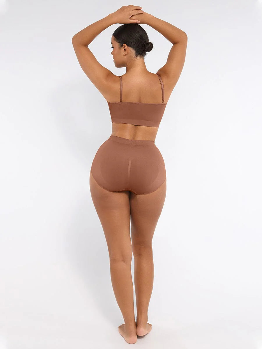 Woman wearing a brown sports bra and leggings set on a white background