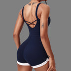 Navy blue swimsuit with criss-cross back design on a plain background