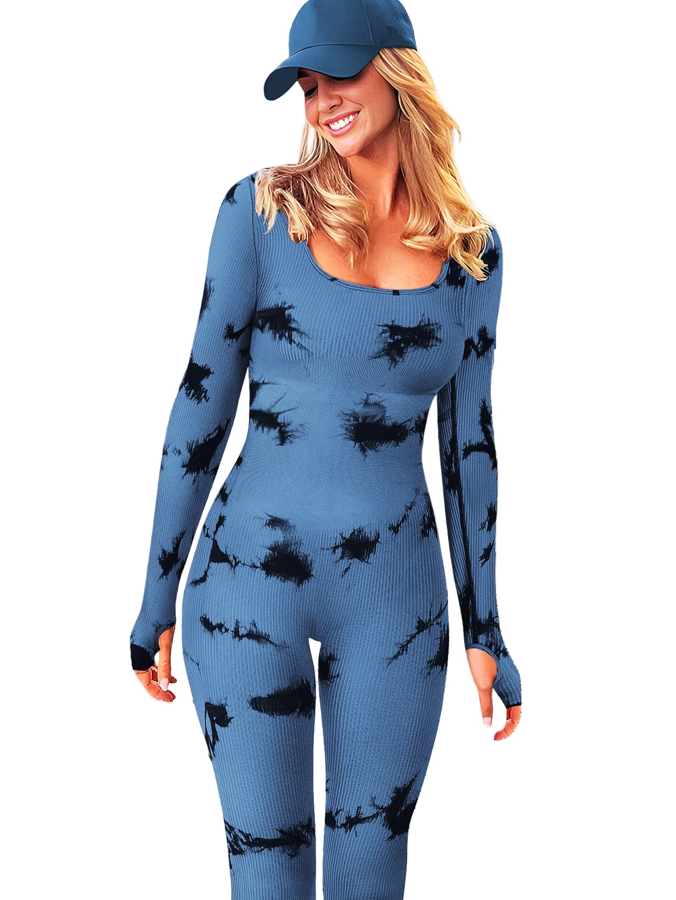 Woman wearing a blue outfit with black splatter patterns on a wooden deck.