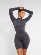 Person wearing a gray bodysuit against a white background