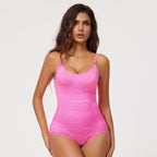 Woman wearing a pink bodysuit against a white background