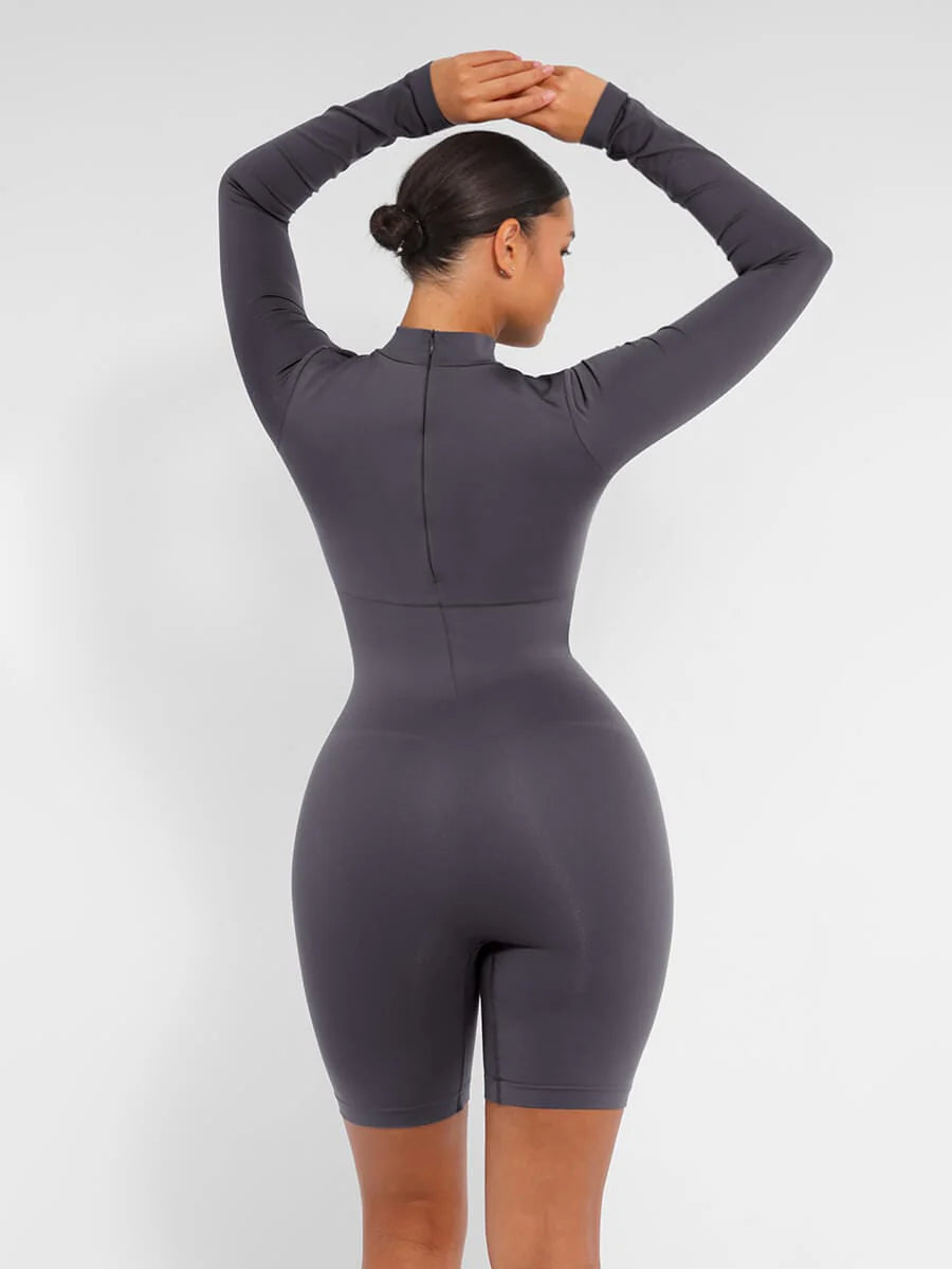 Person wearing a gray bodysuit against a white background