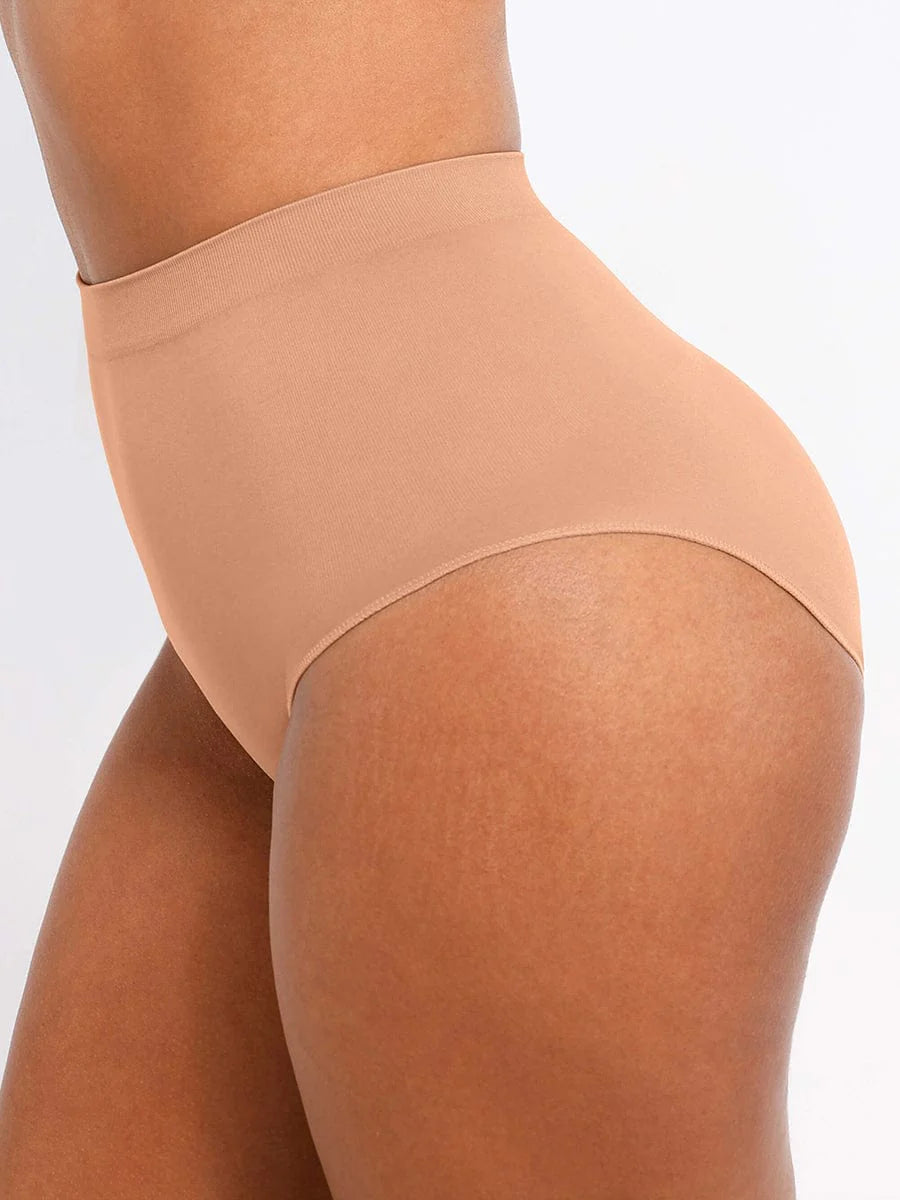 Beige shapewear being worn on a plain background