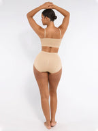 Woman wearing a beige swimsuit on a white background