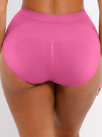 Person wearing bright pink high-waisted underwear on a plain background