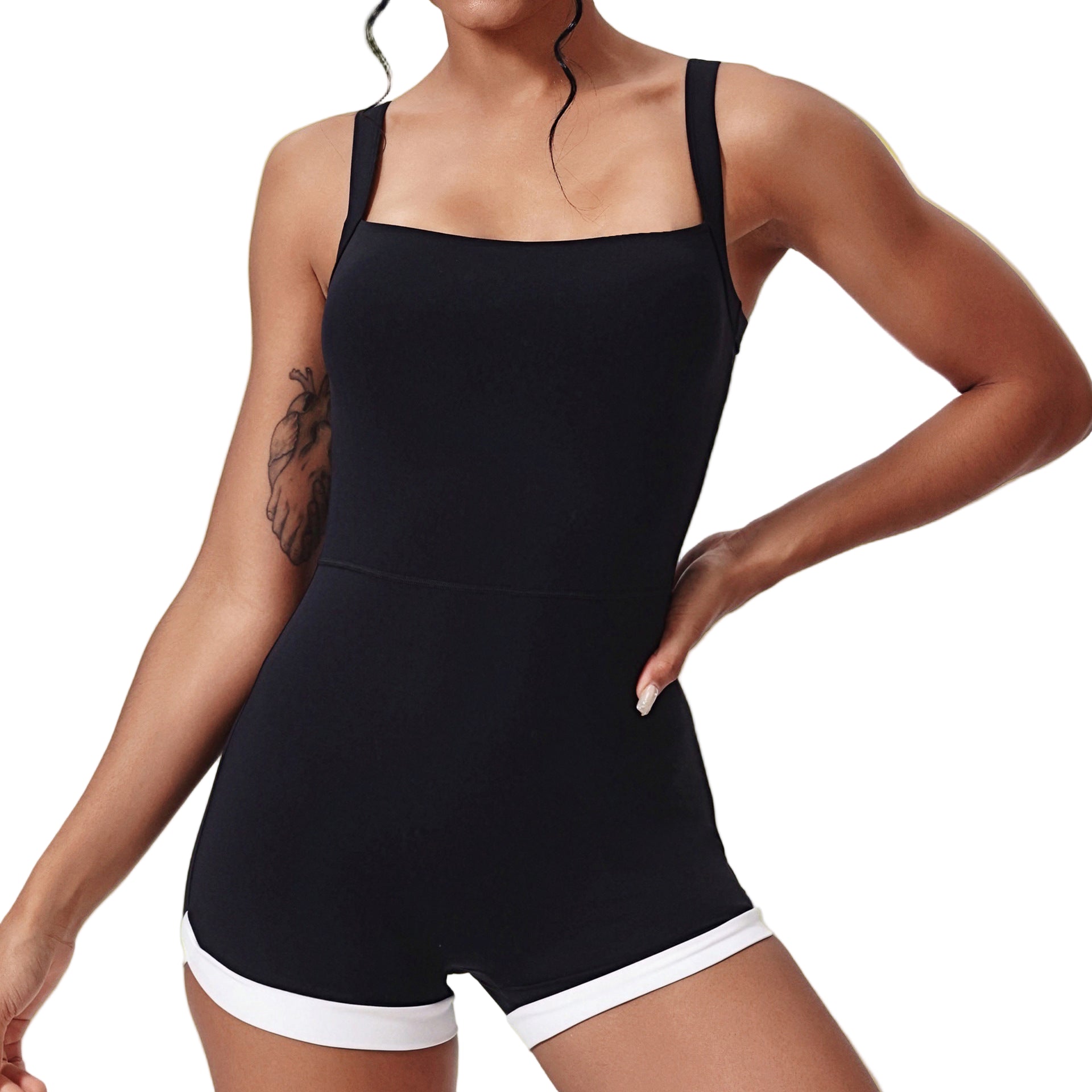 Person wearing a black tank top and white shorts on a plain background