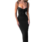 Black dress with lace detailing on a textured wall background