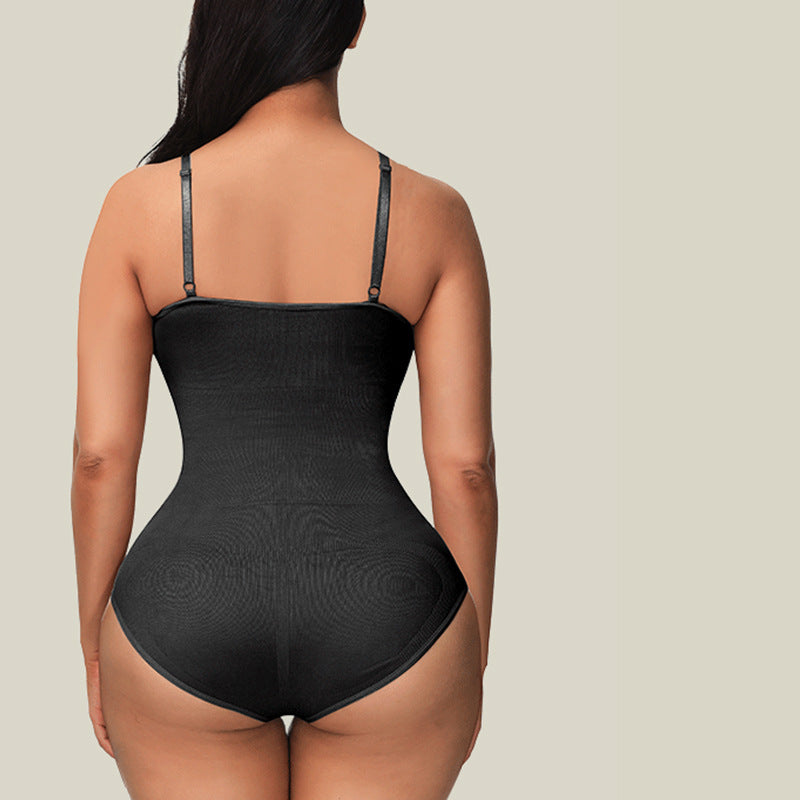 Black bodysuit worn by a person on a beige background