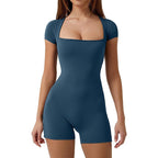 Woman wearing a blue bodysuit on a white background