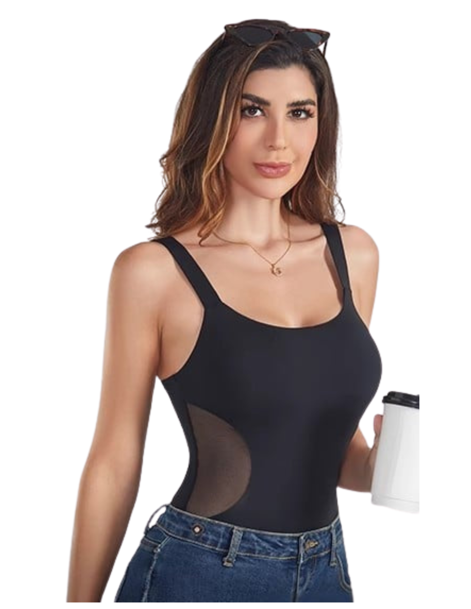 Woman wearing a black bodysuit with sheer panels, holding a white cup.