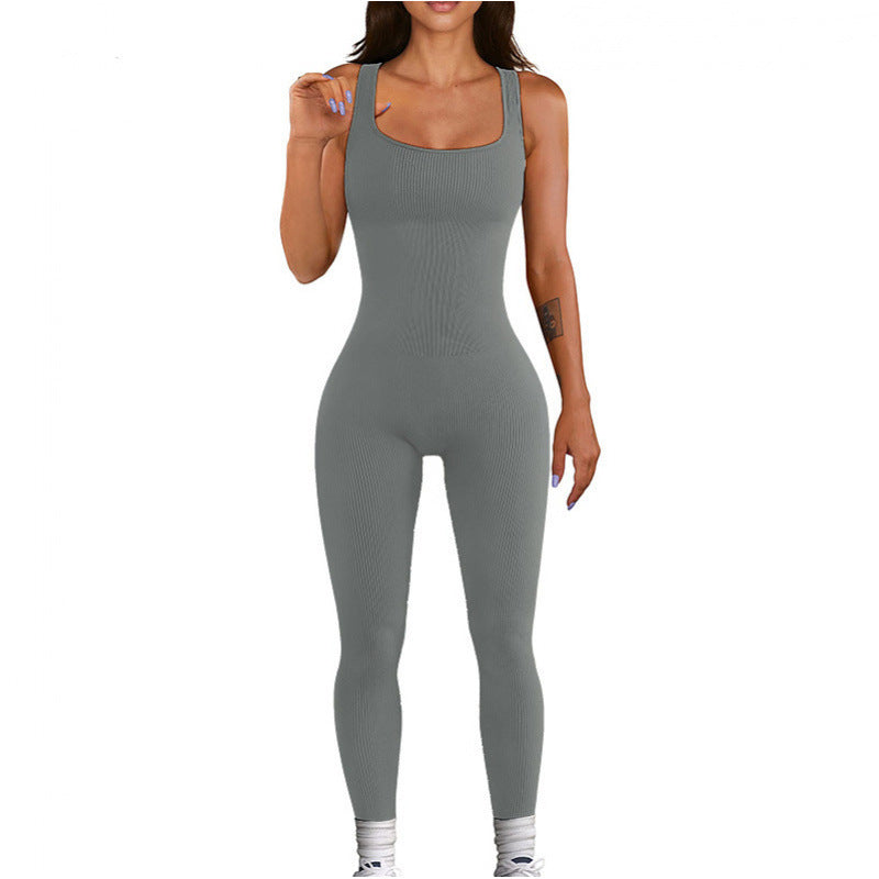 Woman wearing a gray jumpsuit on a white background