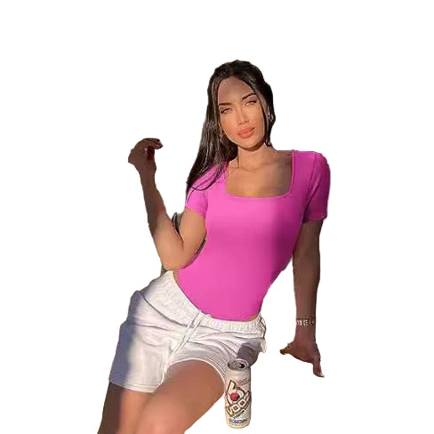 Woman in a pink top and white shorts sitting outdoors with a can of drink.