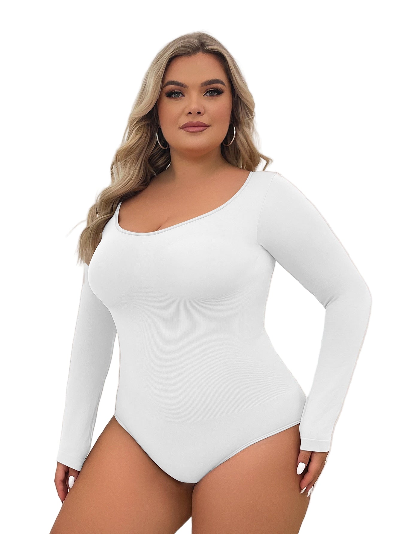 Woman wearing a white long-sleeve bodysuit against a neutral background