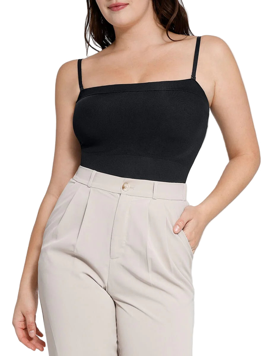 Woman wearing a black top and beige pants on a white background