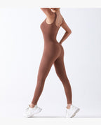 Person wearing a brown bodysuit on a white background