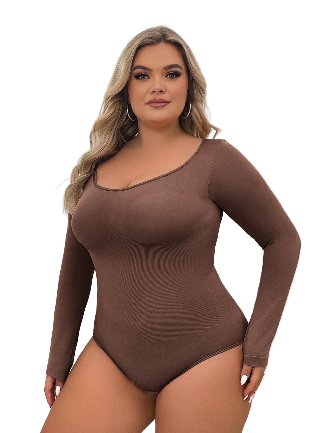 Woman wearing a brown long-sleeve bodysuit against a white curtain background
