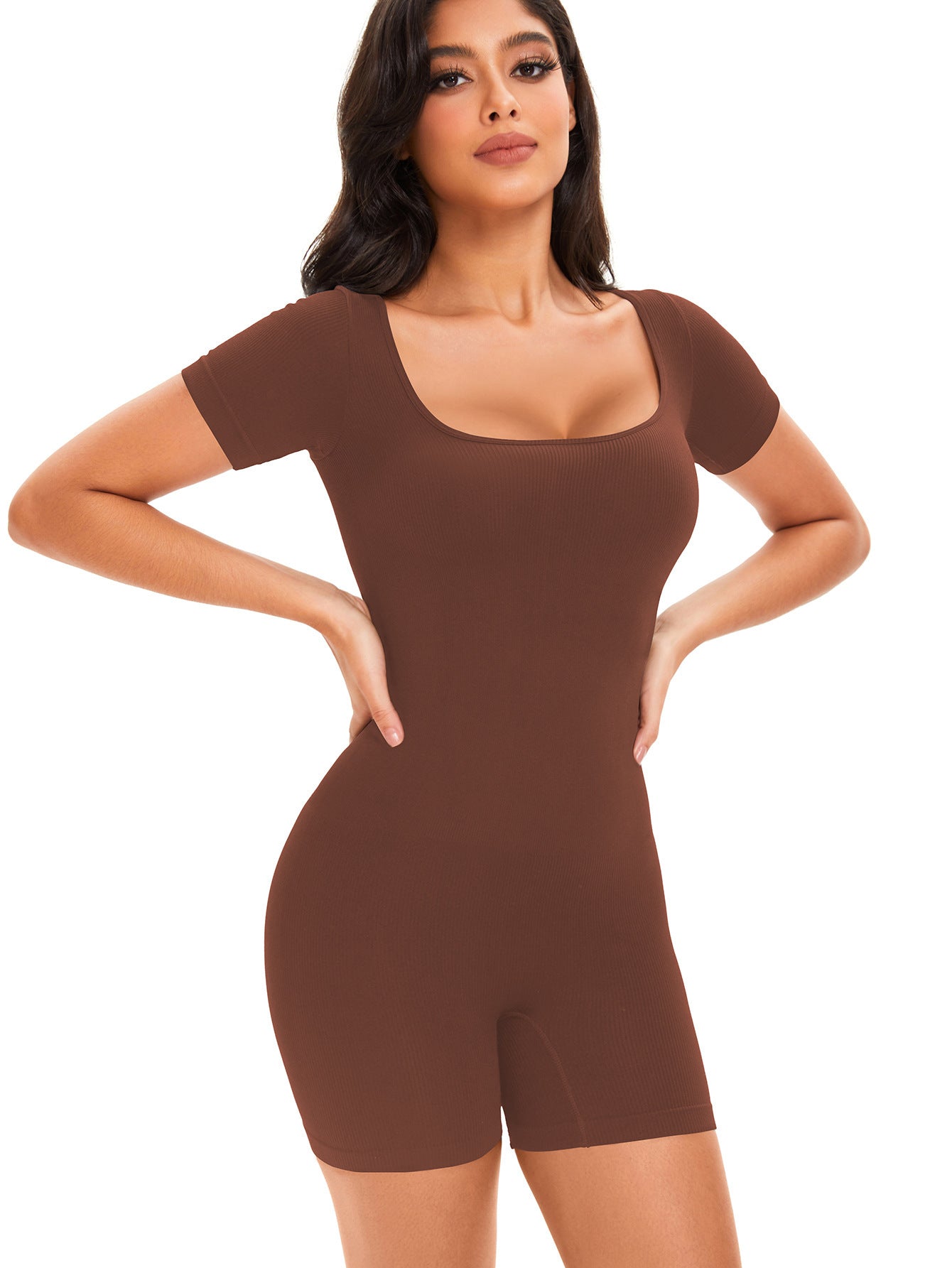 Woman wearing a brown bodysuit on a white background