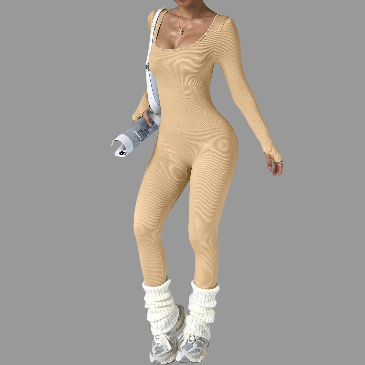 Person wearing a beige bodysuit with a gray background