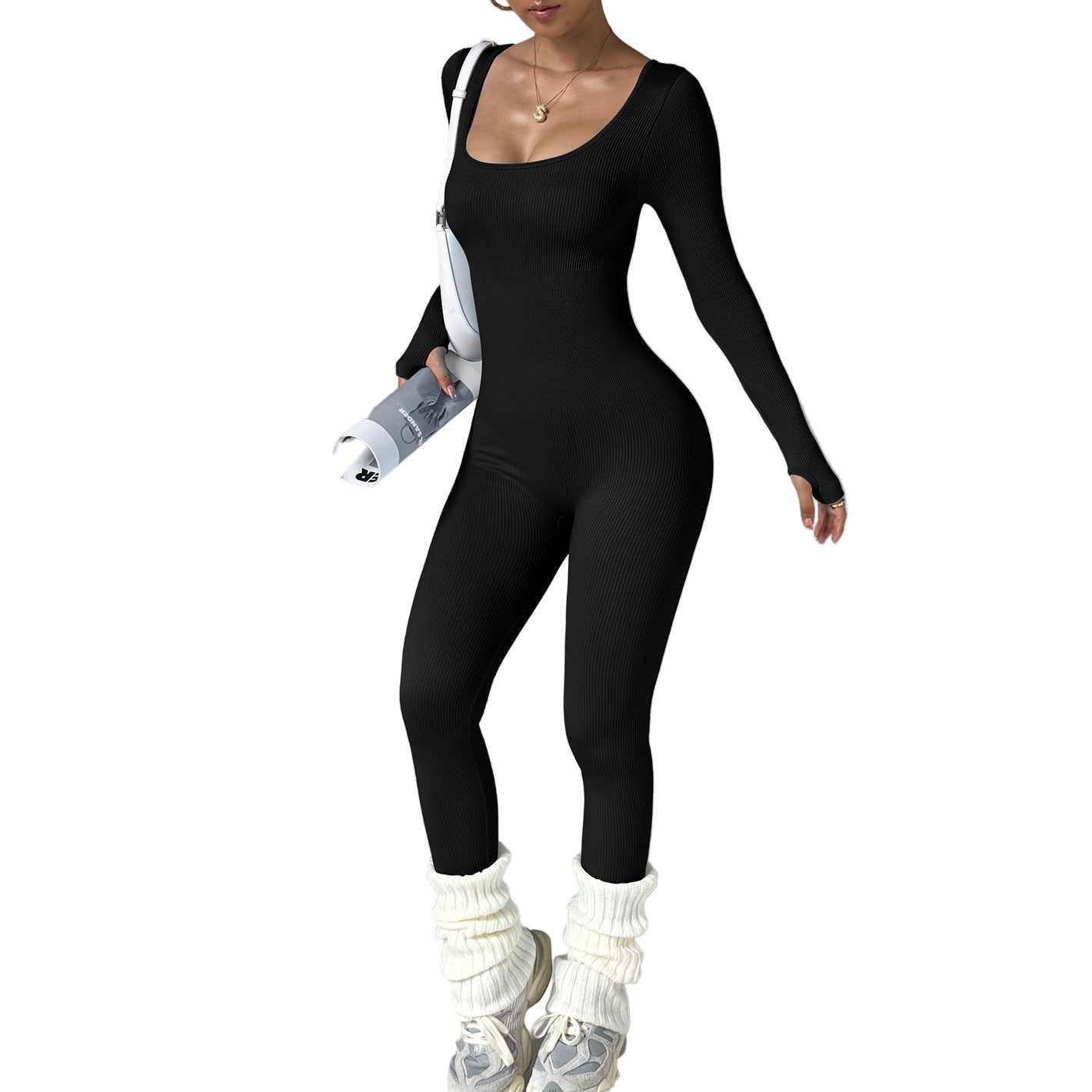 Person wearing a black bodysuit with white leg warmers on a gray background
