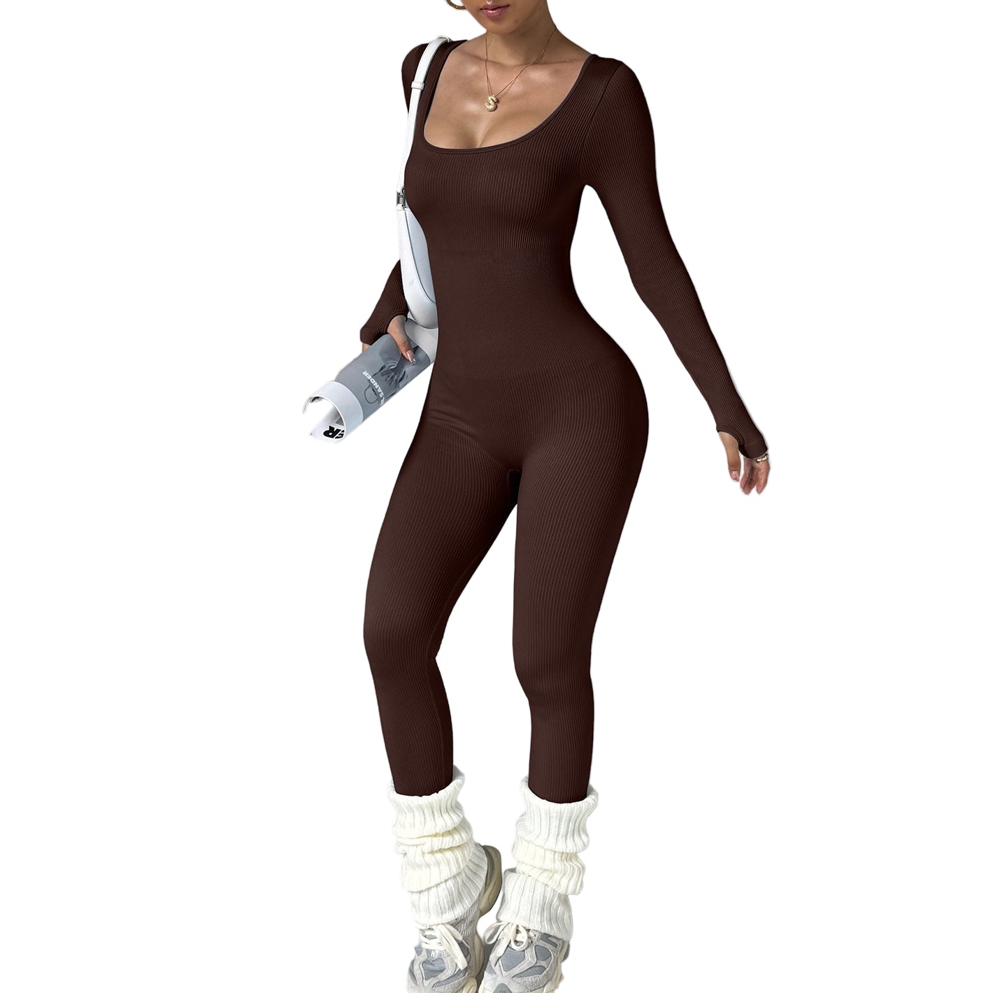 Person wearing a brown bodysuit with white leg warmers on a gray background