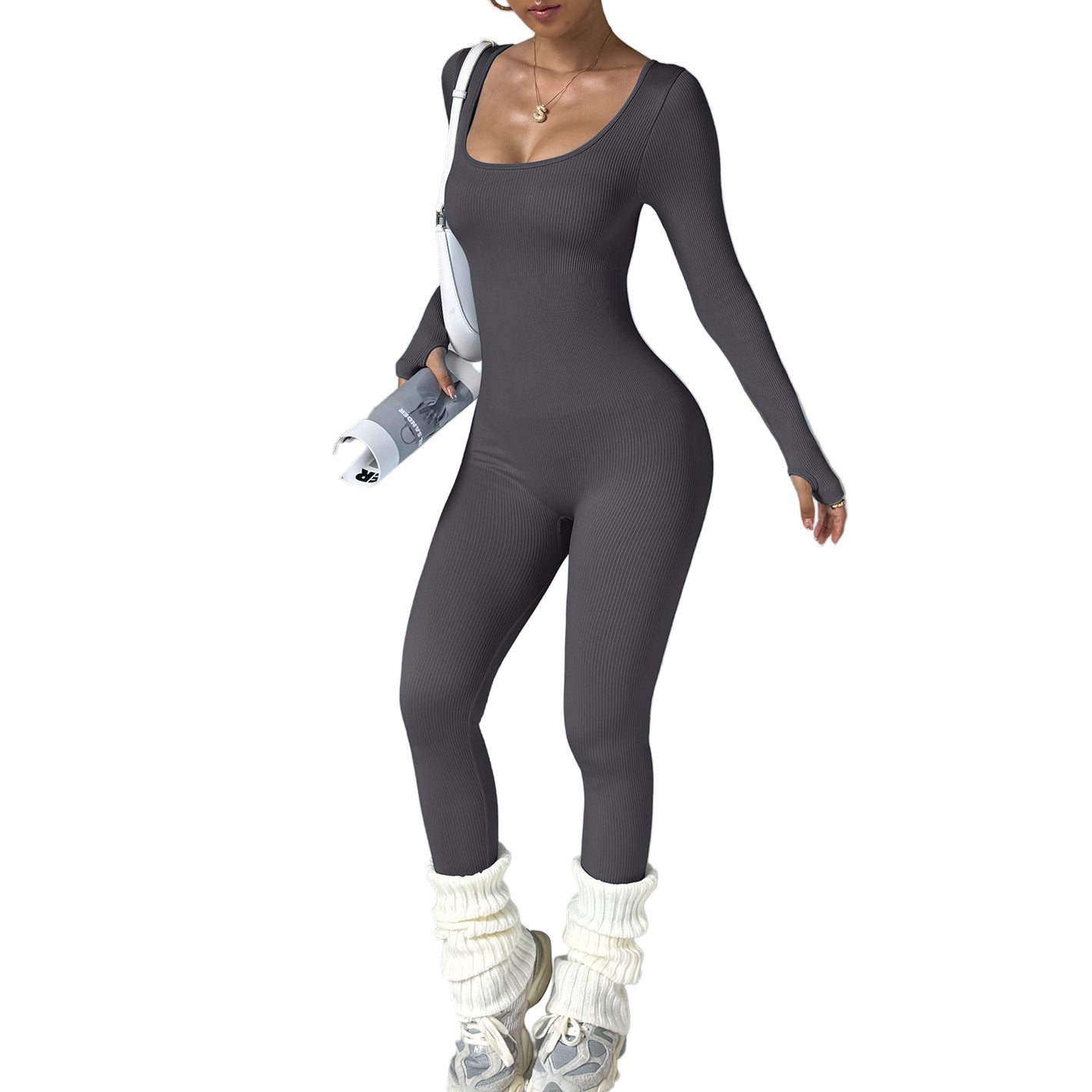 Person wearing a gray bodysuit with white leg warmers on a gray background