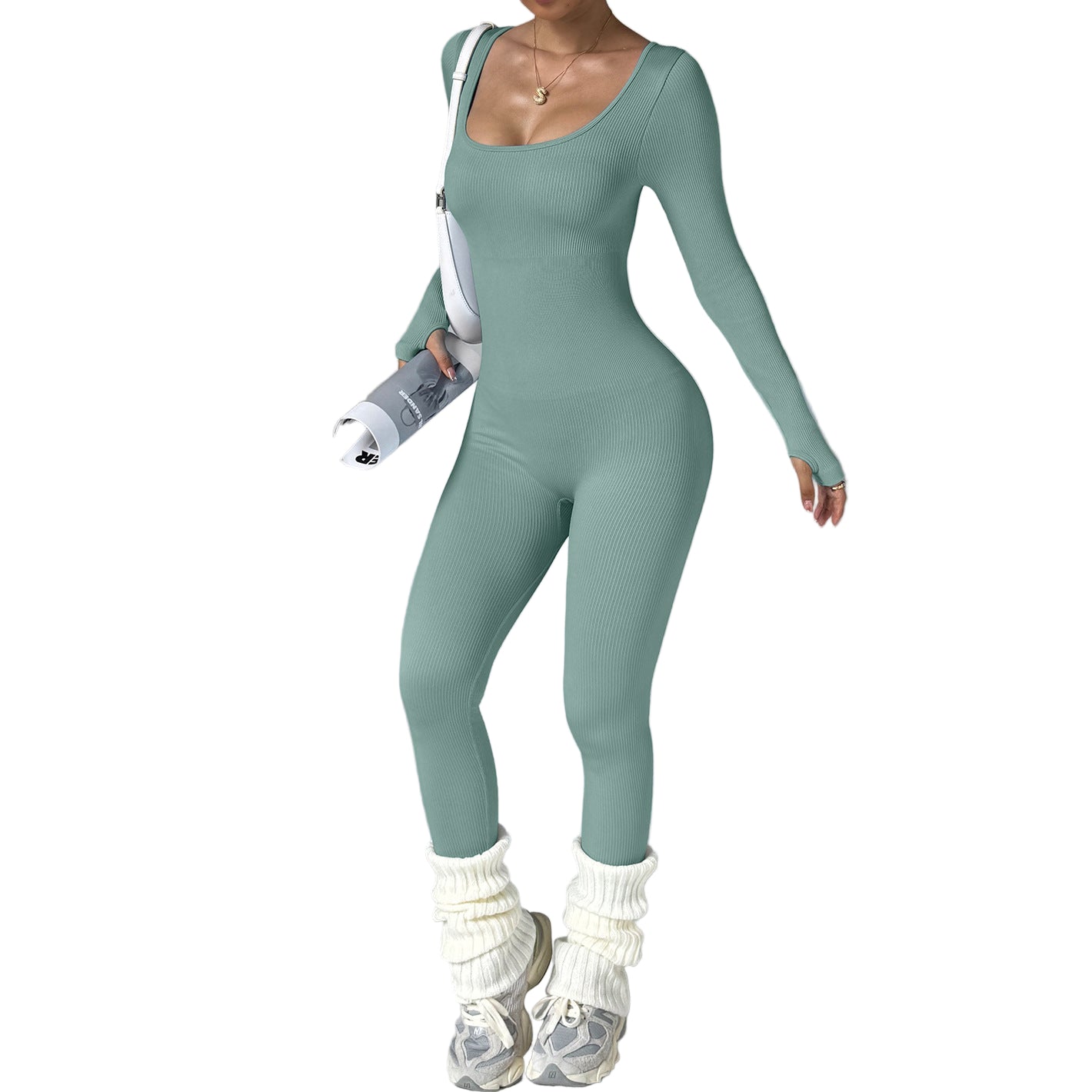 Person wearing a teal jumpsuit with white shoes and socks on a gray background