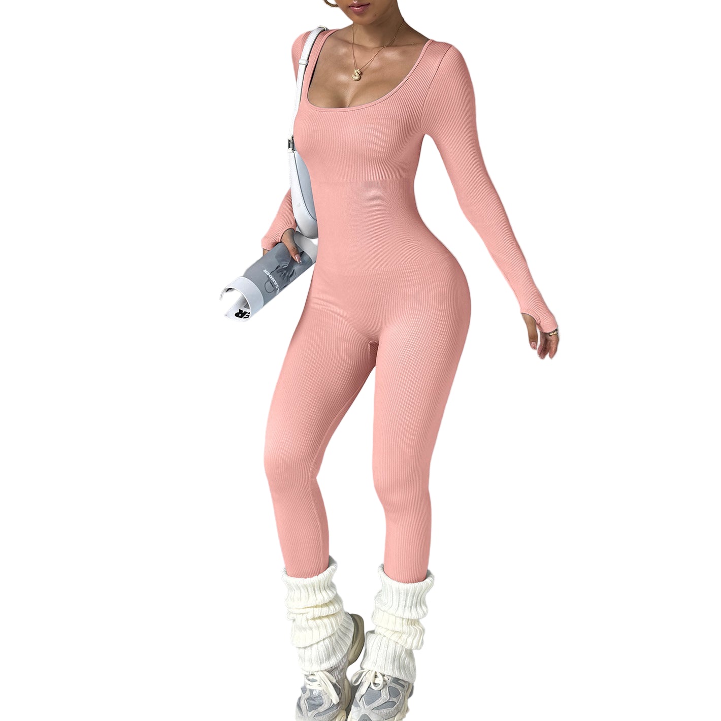 Person wearing a pink bodysuit with white sneakers and socks on a gray background