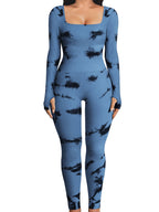 Blue jumpsuit with black abstract pattern worn by a person indoors.