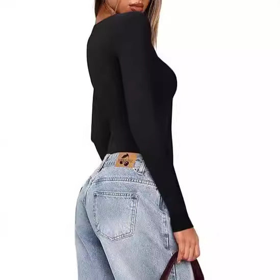 Person wearing a black long-sleeve top and light blue jeans on a white background