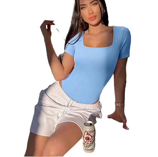 Woman in a blue top and white shorts holding a can of VooDoo beer on a white background