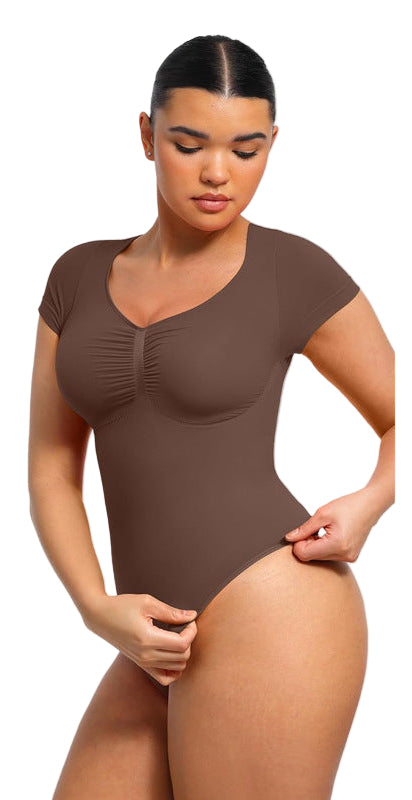 Woman wearing a brown bodysuit with text about tummy control on a gray background