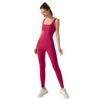 Woman wearing a pink bodysuit on a white background