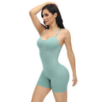 Woman wearing a light green bodysuit on a white background