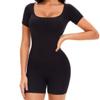Black shapewear bodysuit worn by a model on a white background
