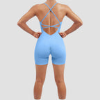 Light blue bodysuit with criss-cross back design on a plain background