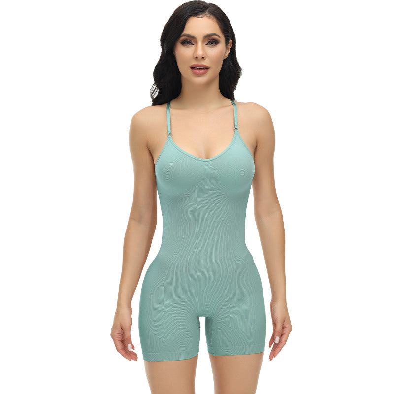 Woman wearing a light green bodysuit against a white background