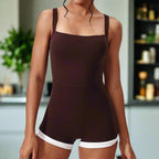 Brown romper with white trim worn by a model on a light gray background