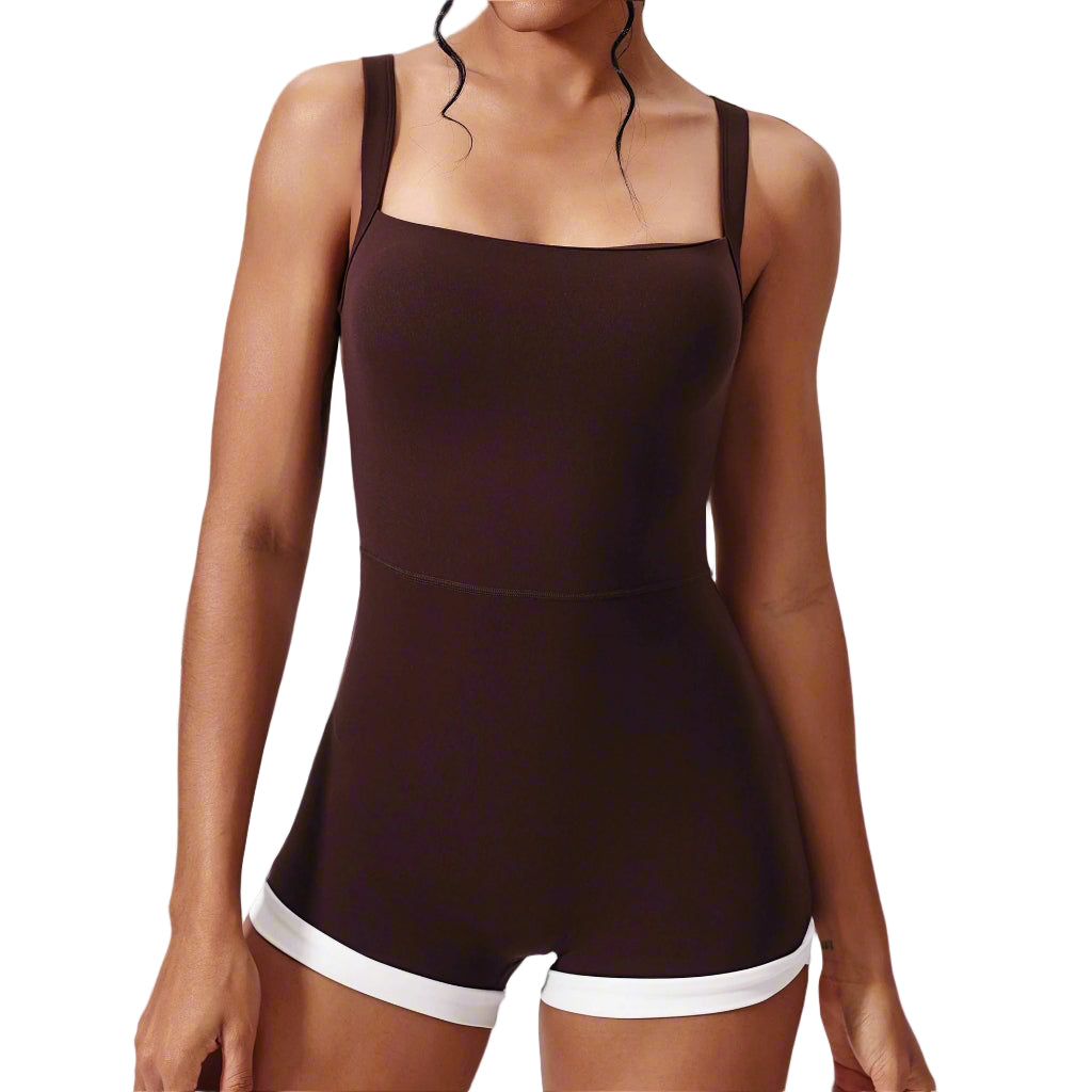 Brown romper with white trim worn by a model on a light gray background