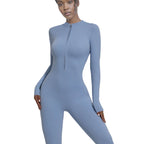 Person wearing a blue bodysuit on a light gray background