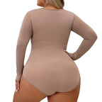 Person wearing a beige bodysuit against a white curtain background