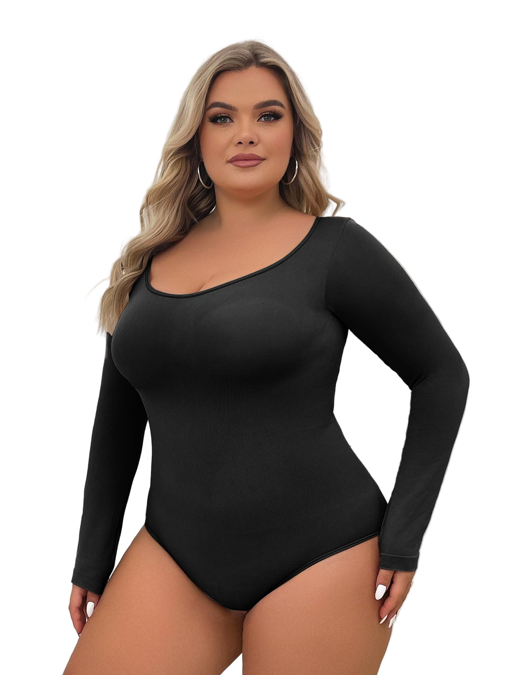 Woman wearing a black long-sleeve bodysuit against a white curtain background