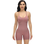 Woman wearing a pink bodysuit against a white background