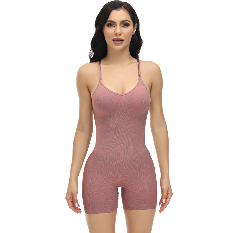 Woman wearing a pink bodysuit against a white background