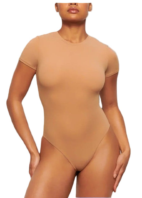 Woman wearing a beige bodysuit on a blue background
