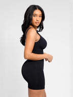 Woman wearing a black sleeveless dress against a light gray background